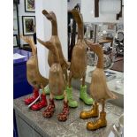 WOODEN DUCKS, a set of five, solid wood polished finish with coloured boots, tallest 62cm H,