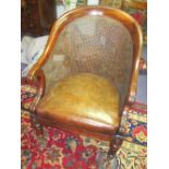 LIBRARY BERGERE, Regency mahogany with caned back and drop in tan leather pad seat,