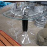 DINING TABLE, 1970's the circular glass top on a perspex base with black column, 90cm x 77cm H.