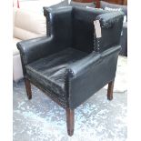 WING ARMCHAIR, in black distressed leather with brass studs on square legs with spade feet, 87cm W.