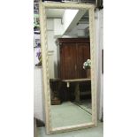 WALL MIRROR, white painted with leaf entwined rectangular frame, 206cm x 88cm.