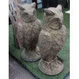 GARDEN OWLS, a pair, reconstituted stone 19th century style on round bases, weathered finish,