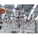 CHANDELIER, Louis VX style twelve branches, in metal with crystal drops, 61cm H, plus chain.