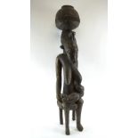 WITHDRAWN LOT SEATED MATERNITY FIGURE, Yoruba people, carved wood, 96cm H maximum.