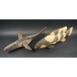 CARVED WOODEN FISH, two various, of West African origin, 62cm L and 61cm L.