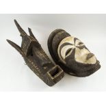 WEST AFRICAN SPIRIT FACE MASK, whitened carved wood, 45cm H; and another in the Dogon manner,