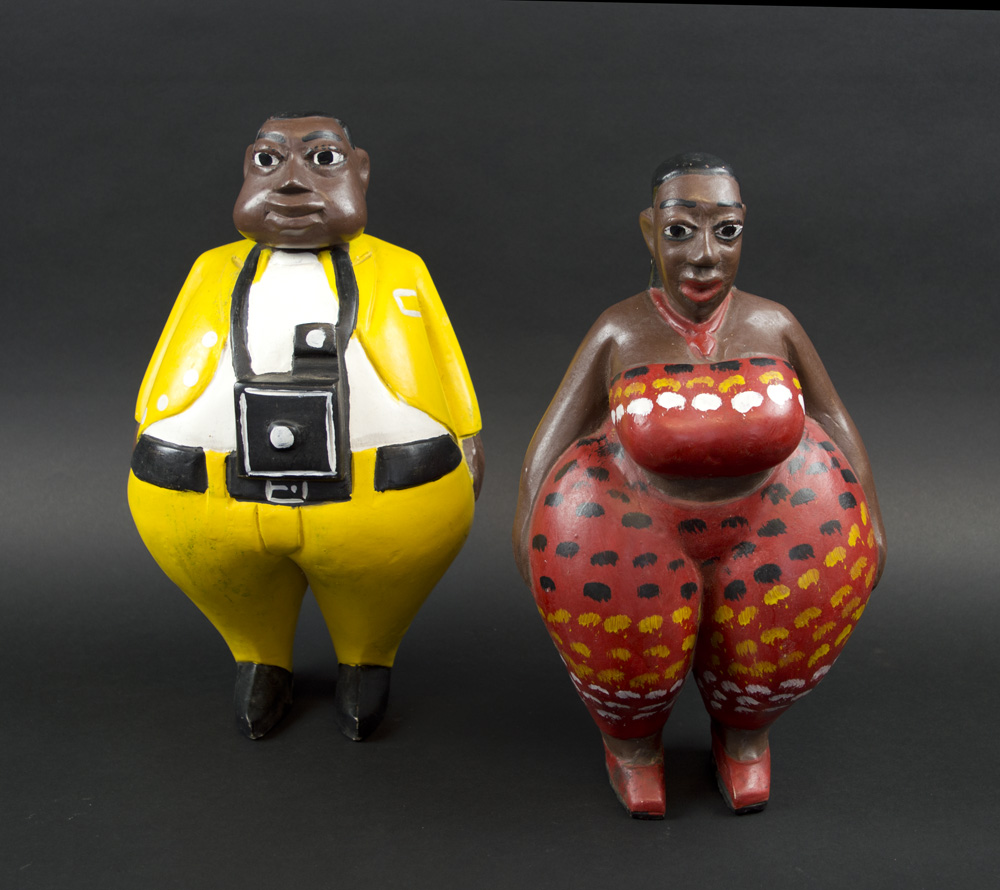 CARICATURE FIGURE CARVINGS, West African, of a husband and wife, painted wood, 33cm H x 32cm W.