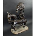 BAULE HORSEMAN CARVING, patinated finish, with integral base, 53cm L x 69cm H overall.