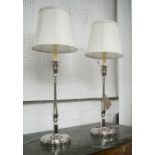 TABLE LAMPS, a pair, candlestick form with cream shades, 82cm H.