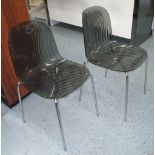 DINING CHAIRS, a set of four, stacking in lucite on tubular metal supports, 44cm.