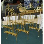 TABLE EASELS, a set of six, in gilded metal finish, 55cm H.