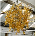 CHANDELIER, amber glass in twisted ribbon design, 90cm x 80cm.