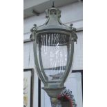 STORM LAMPS, a pair, in a verdigris finish with scroll decoration, 50cm H.