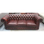 CHESTERFIELD SOFA, burgundy leather three seater with cushion seat and castors, 204cm W.