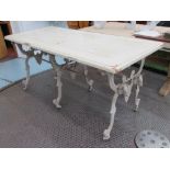 DINING TABLE, with distressed painted wooden top on ornate painted cast iron base on castors,