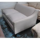 SOFA, of contemporary design in an ivory upholstery with ebonised feet, 78cm x 148cm x 92cm.