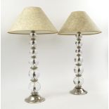 TABLE LAMPS, a pair, graduated glass ball stems on chrome bases, with faux shagreen shades, 60cm H.