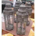 STORM LANTERNS, a set of four, Moroccan style, distressed black metal with glazed panels, 60cm H.