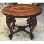 LOW TABLE, Indian teak, with oval carved top on elephant trunk supports, 60cm H x 75cm W x 54cm D.