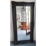 MIRROR, with bevelled plate in ornate black painted frame, 182cm x 95cm.