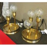 TABLE LAMPS, a pair, with small glass spherical bulbs and circular dished bases, 22cm diam.