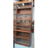 BOOKCASE, mahogany, a stack of seven sections, each with sliding glass doors,