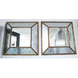 WALL MIRRORS, a pair, gilt framed with bevelled square central plate and cushion border,