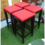 BARSTOOLS, a set of four, with red cushioned seats on square ebonised supports,