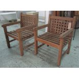 PORTCULLIS GARDEN ARMCHAIRS, a pair, weathered teak slatted with lattice back.