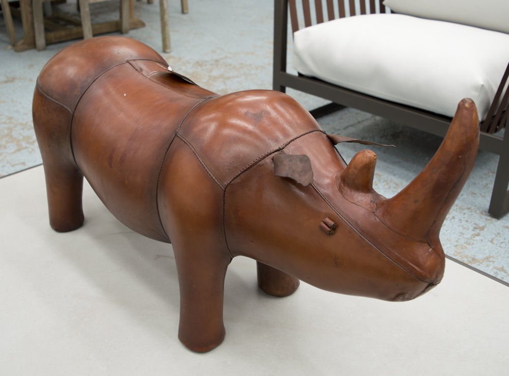 FOOTSTOOL, in the form of a rhinocerous, in tanned leather, 86cm L.