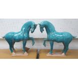 TANG HORSES, a pair, in blue glaze, 44cm L.