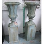 GARDEN URNS, a pair, on plinths, in blue/grey finish, 80cm x 132cm.