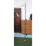 EASEL, with integral light in brass finish, on triform support, 202cm H.