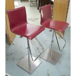 BAR STOOLS, a pair, red leather, each 44cm W.