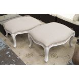 FOOTSTOOLS, a pair, in neutral fabric on distressed white painted frames, 77cm x 63cm x 39cm H.