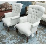 ARMCHAIRS, a pair, in buttoned neutral fabric on turned castor supports, 65cm W.