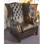 WING ARMCHAIR, Georgian style in dark brown leather with buttoned back and cushion seat, 98cm W.