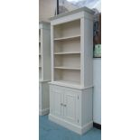 CREAM PAINTED BOOKCASE, with cupboard beneath, 86cm W x 34cm D x 202cm H.