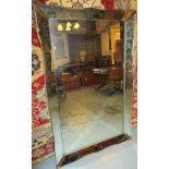 WALL MIRROR, mid 20th century Continental with shaped, angled and bevelled side panels,