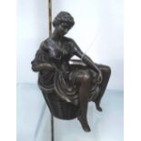 BRONZE, of a lady sitting in a basket, 22cm H.