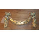 DECORATIVE SWAG, gilt with green ribbon, 62cm x 34cm H.