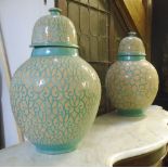 MOROCCAN LIDED POTTERY JARS, two similar, each with geometric decoration, 63cm H (with faults,