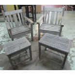 GARDEN ARMCHAIRS, a pair, weathered teak of slatted construction each with companion table,