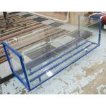 OCCASIONAL TABLE, glass construction, with shelves below on a blue metal base,
