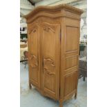 ARMOIRE, carved wood with panelled doors and sides, 70cm D x 122cm W x 221cm H.