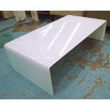 LOW TABLE, in opaque glass of curved form, 130cm L x 62cm D x 38cm H.