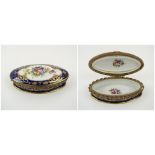LIMOGES TRINKET BOX, oval ceramic decorated a floral cartouche on a blue and gilt ground, 15.