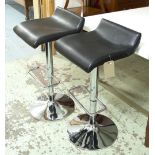 BAR STOOLS, a set of four, in black on chromed metal supports, adjustable height, by Actona, 88cm H.