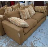 SOFA, in a soft burnt umber fabric on oversized slim block supports and a scatter of cushions,