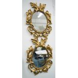 MIRRORS, a pair, oval, in ornate gilded frame, 90cm x 66cm.